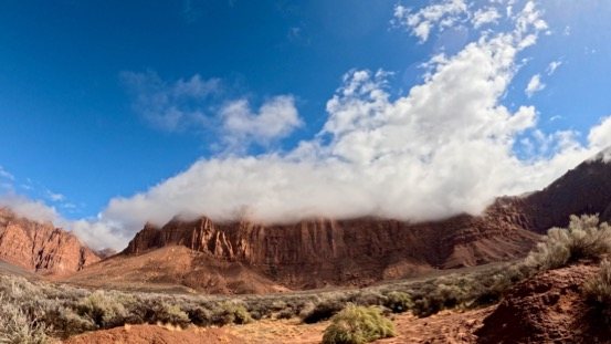 Clouds drifting over red cliffs near Ivins, Utah